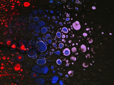 A black background with red, white and blue bubbles