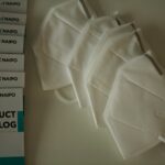 white polo shirt on white table
